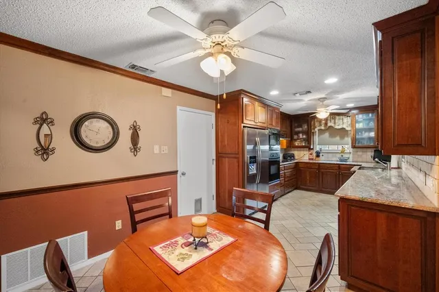 a view of a dining room with furniture and a chandelier