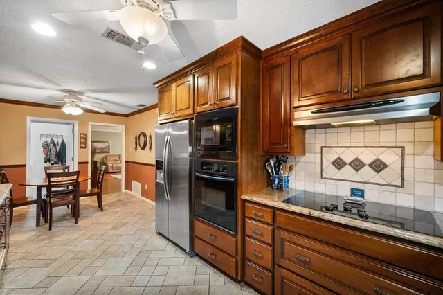 a kitchen with stainless steel appliances granite countertop a sink and cabinets