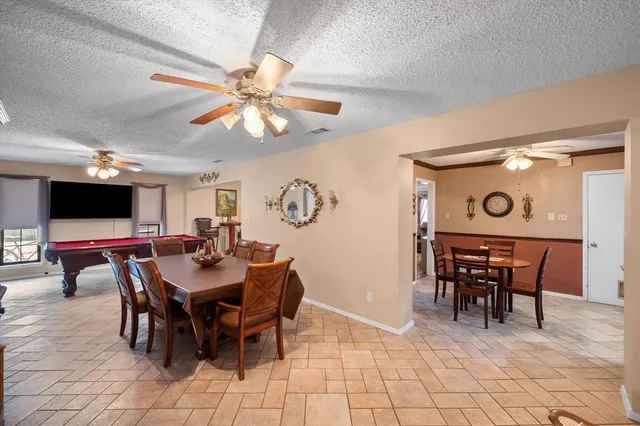 a view of a dining room with furniture and a chandelier