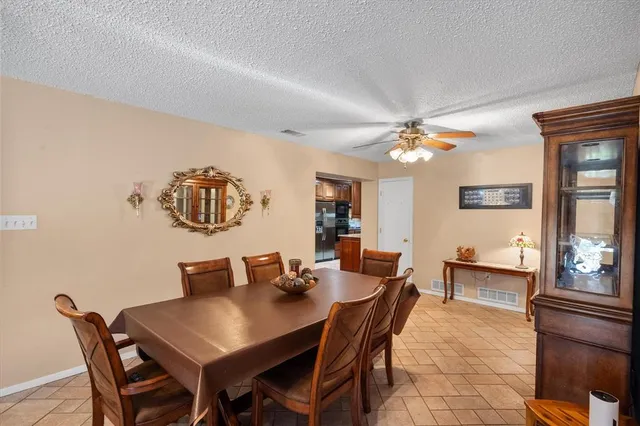 a view of a dining room with furniture and chandelier
