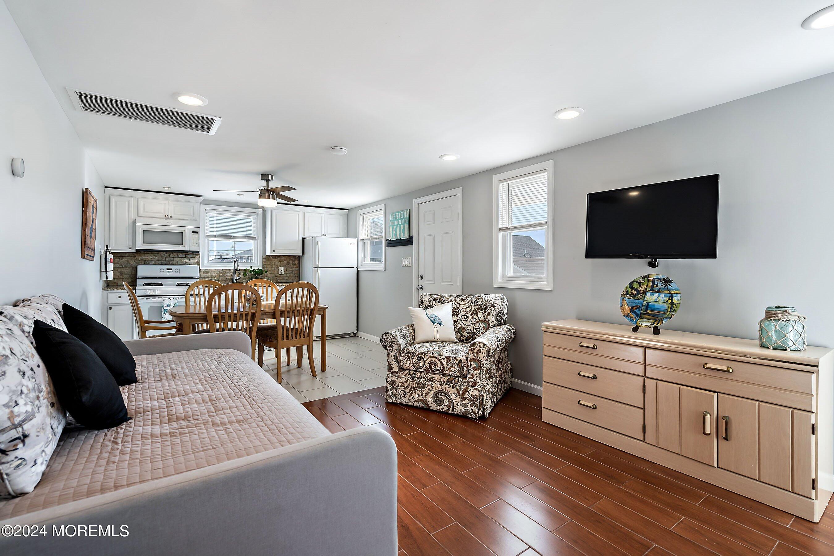 212 Randall Avenue Point Pleasant Beach, NJ 08742 - Photo 12 of 18 a living room with furniture and a flat screen tv