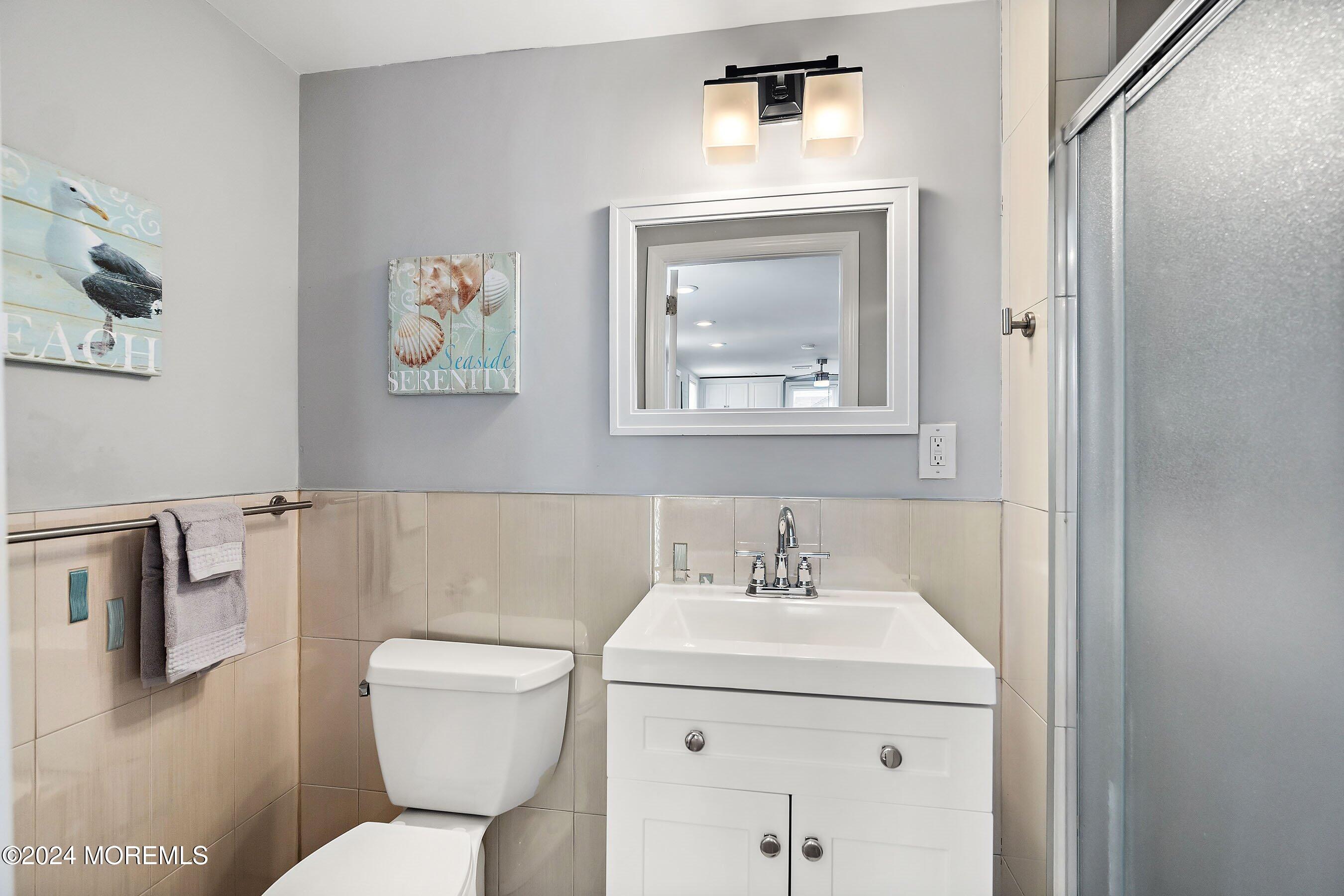 212 Randall Avenue Point Pleasant Beach, NJ 08742 - Photo 13 of 18 a bathroom with a toilet sink and mirror