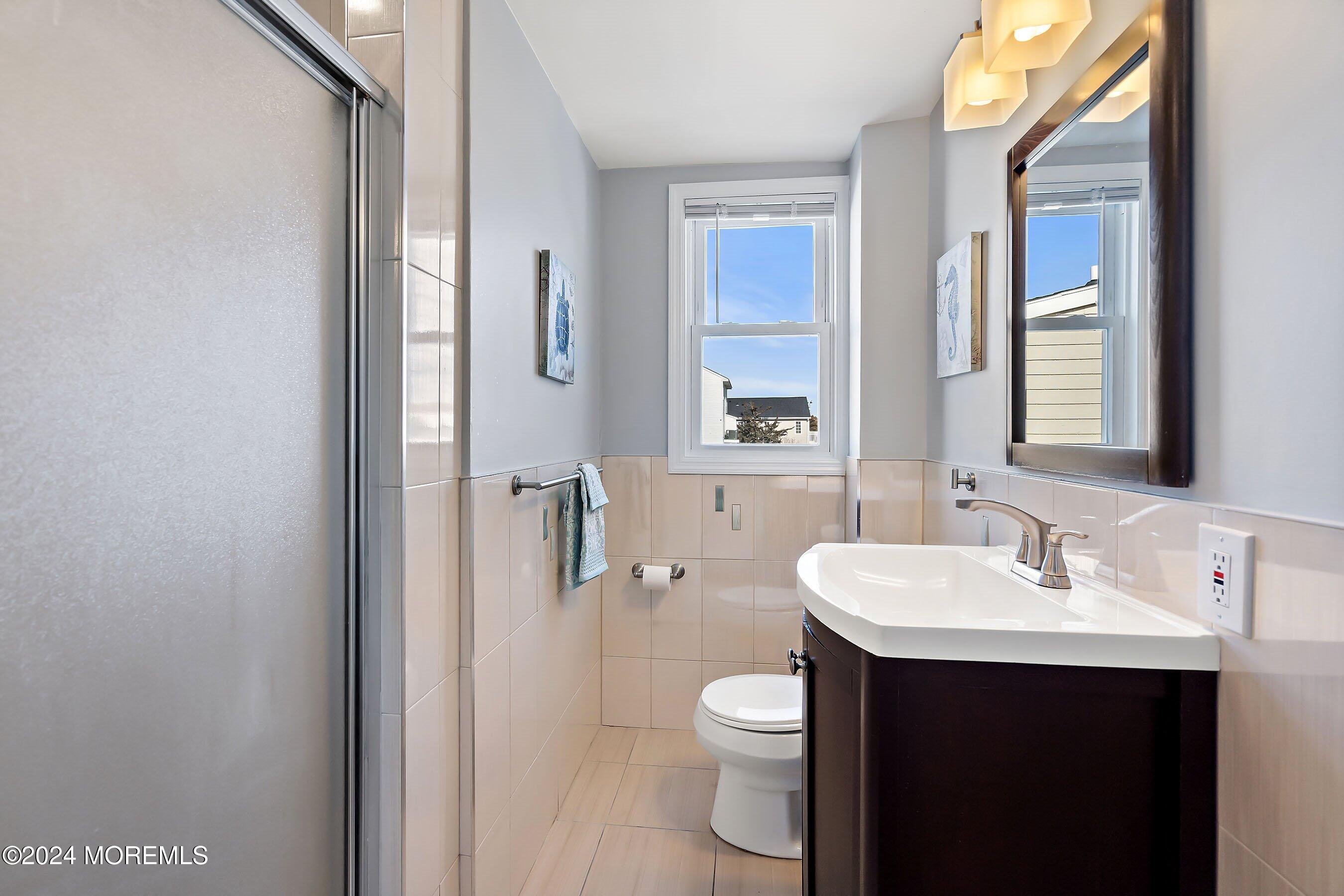 212 Randall Avenue Point Pleasant Beach, NJ 08742 - Photo 6 of 18 a bathroom with a sink toilet and mirror