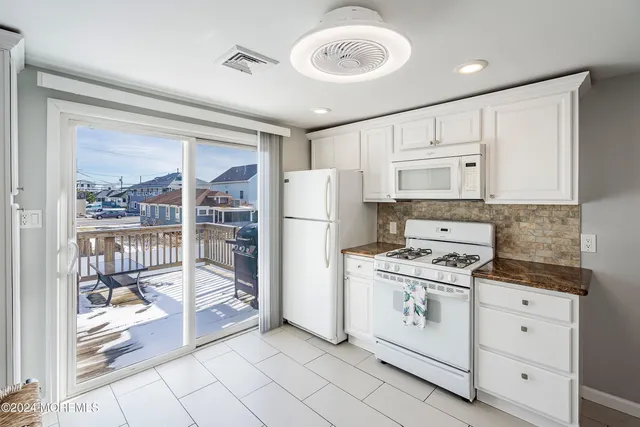 a view of a dining room with furniture and front door