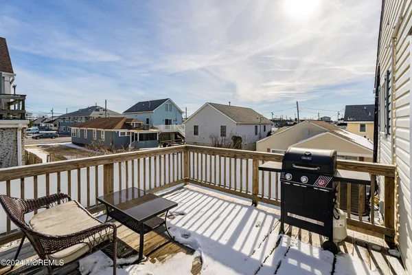 a kitchen with stainless steel appliances granite countertop a dining table chairs refrigerator and cabinets
