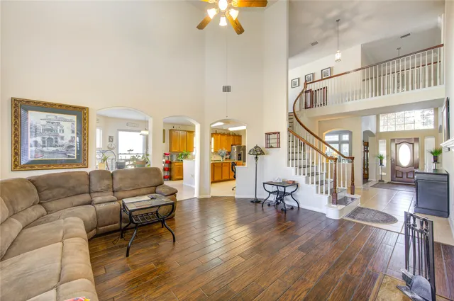 a living room with furniture a fireplace a flat screen tv and a window
