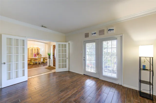 a view of a dining room with furniture a chandelier and wooden floor