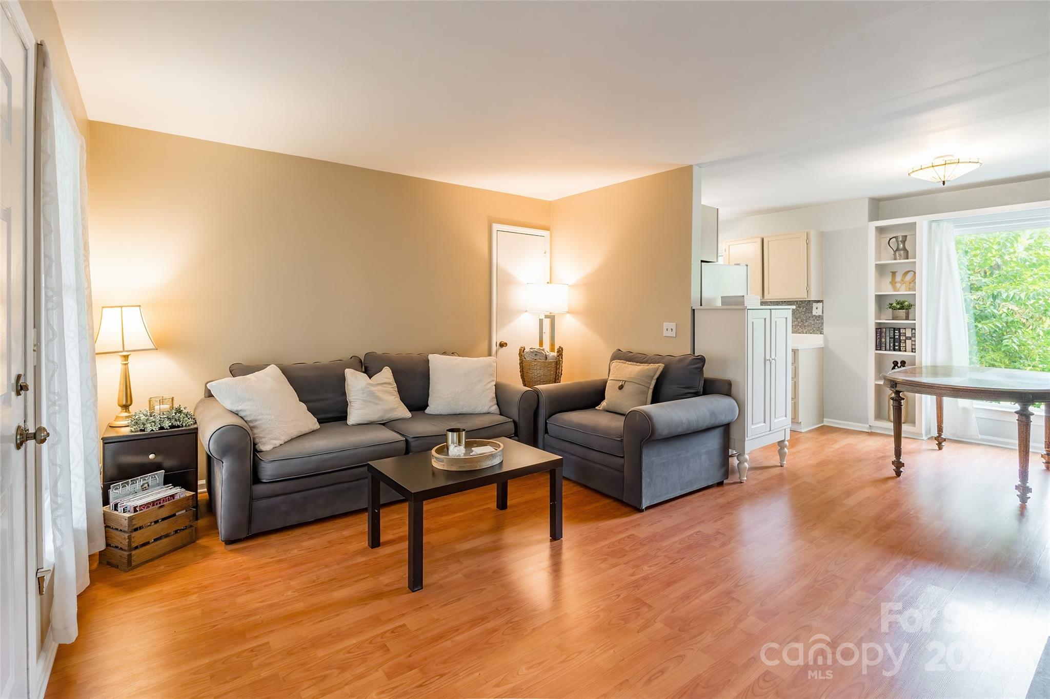 430 Queens Road, Unit 322 Charlotte, NC 28207 - Photo 5 of 20 a living room with furniture and a large window