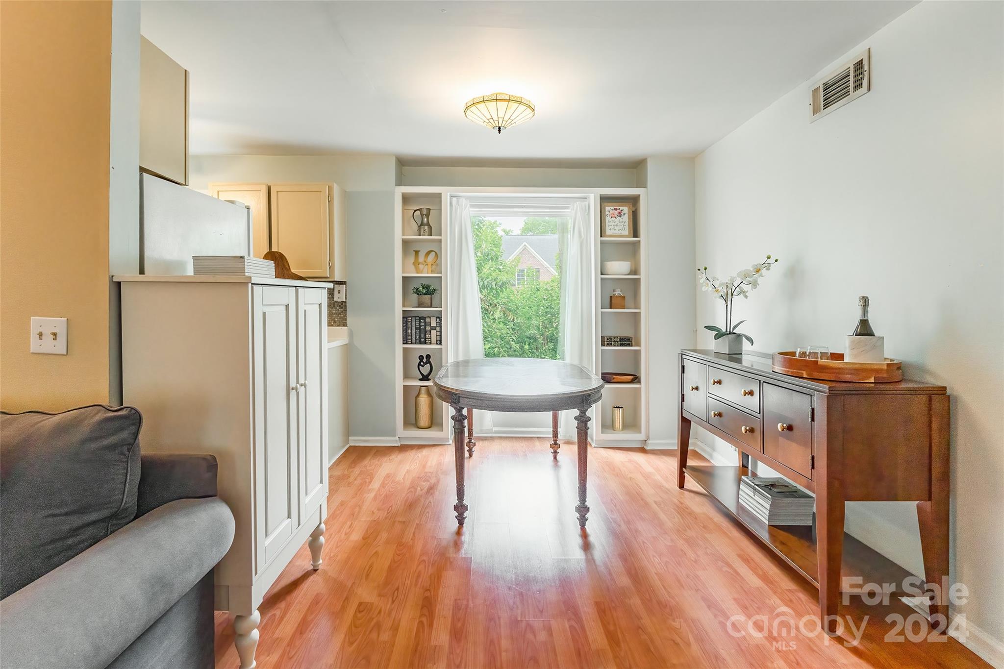 430 Queens Road, Unit 322 Charlotte, NC 28207 - Photo 7 of 20 a living room with furniture and a wooden floor
