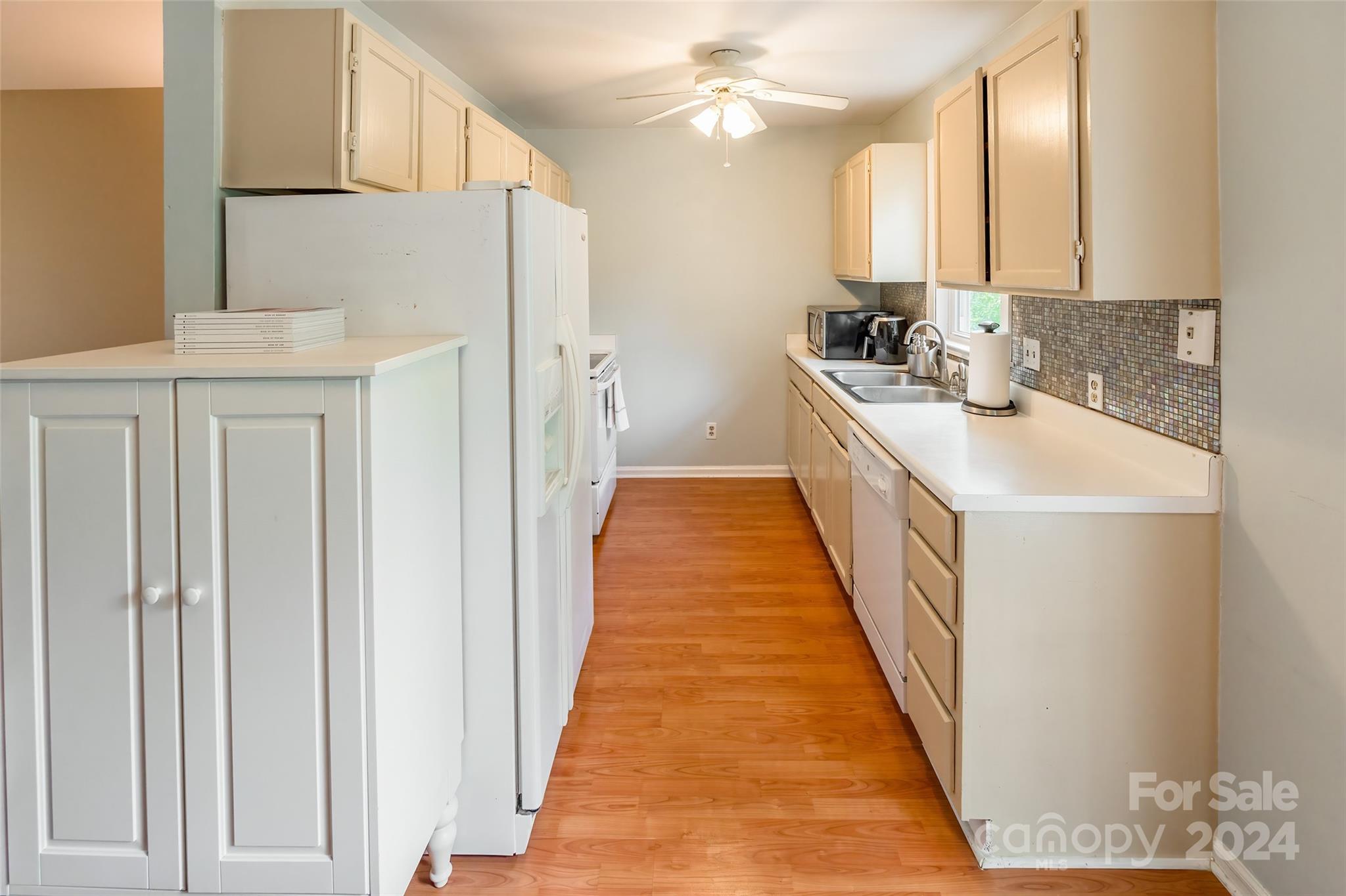430 Queens Road, Unit 322 Charlotte, NC 28207 - Photo 8 of 20 a kitchen with stainless steel appliances a sink stove and cabinets