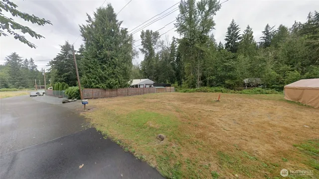 a view of a street with a yard and a fountain