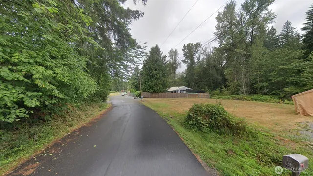a view of a pathway with a wrought fence