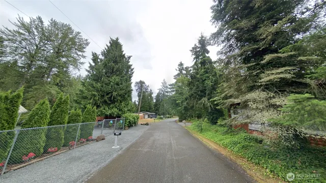 a view of a street with cars parked