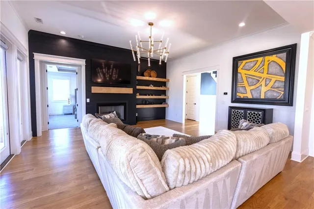 a living room with fireplace furniture and a chandelier
