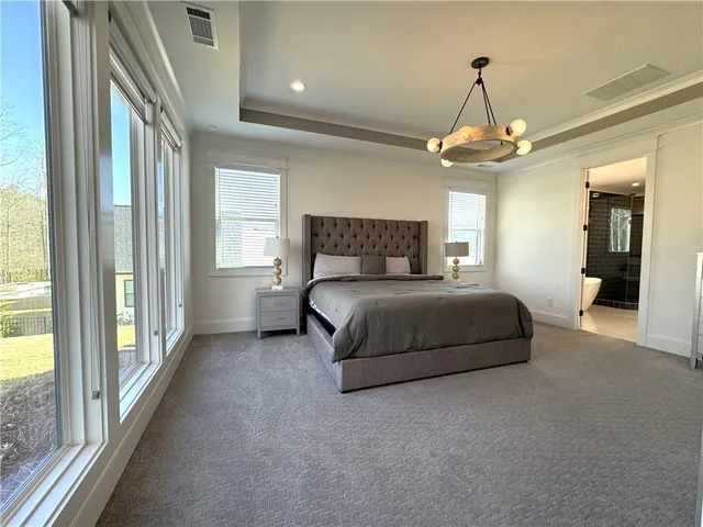 a spacious bedroom with a bed and window