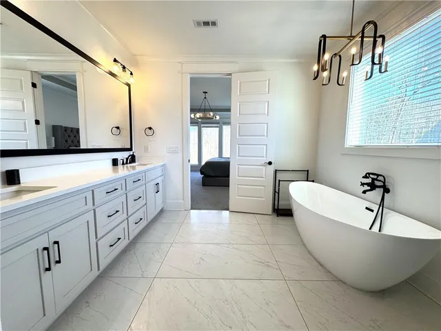 a bathroom with a tub and shower