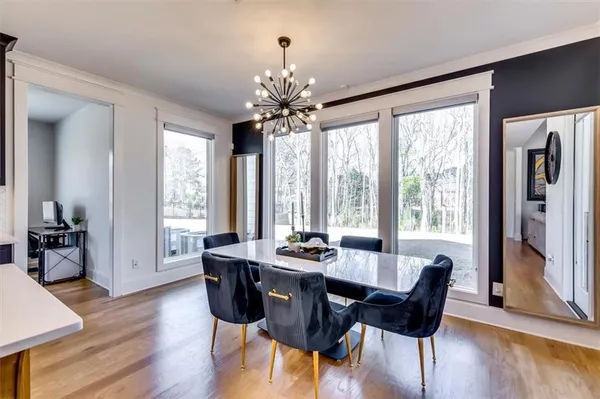 a living room with furniture window and potted plants