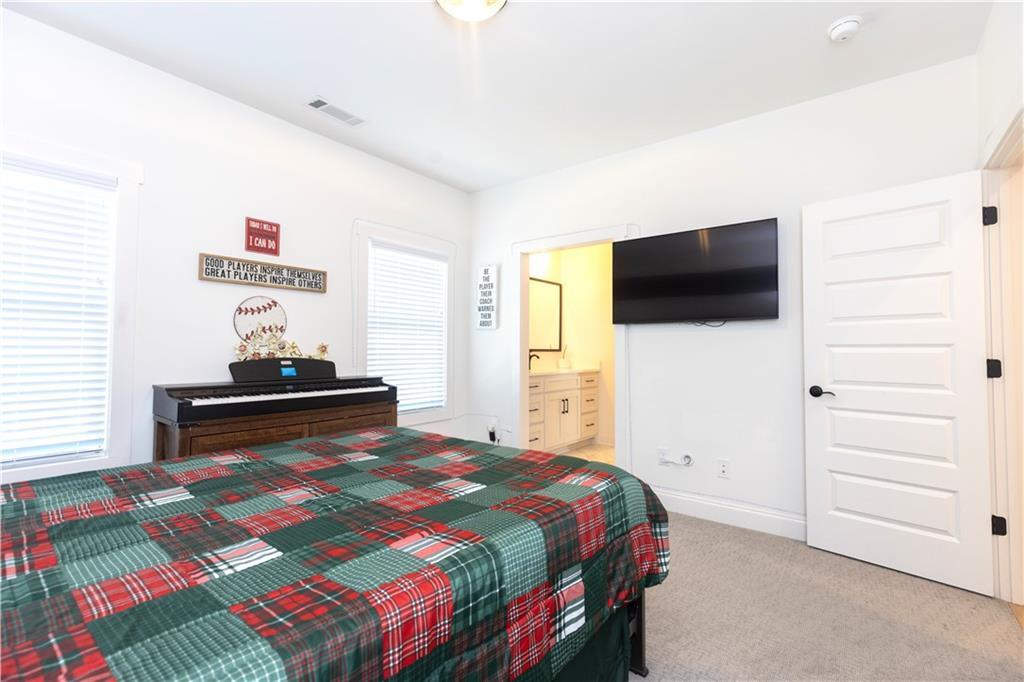 155 Dean Drive Tyrone, GA 30290 - Photo 29 of 50 a bedroom with a bed and a flat screen tv