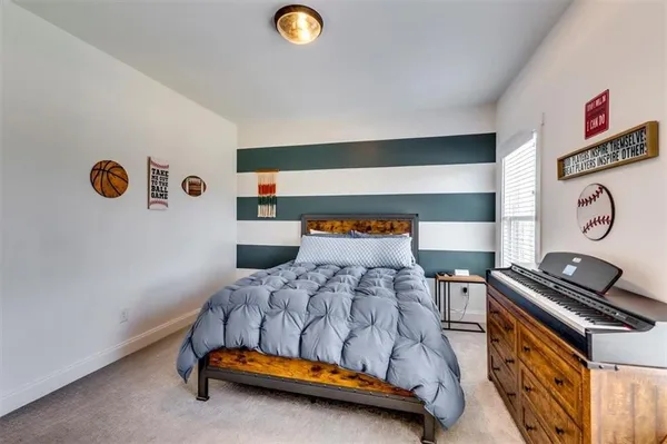 a bedroom with a bed and a dresser