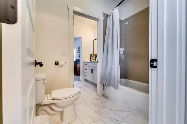 a spacious bedroom with a bed and a chandelier