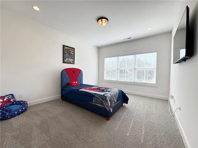 a living room with furniture and a ceiling fan