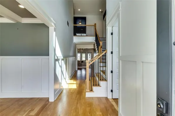 a view of entryway and hall with wooden floor