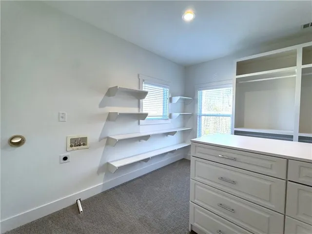 a view of a livingroom with workspace and a window
