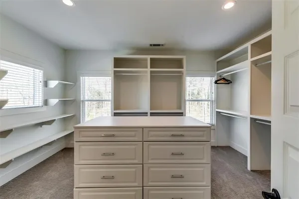 a view of large house with a yard covered in snow