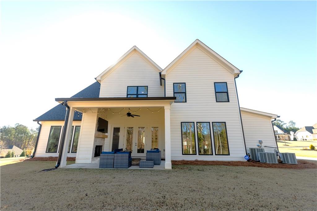 155 Dean Drive Tyrone, GA 30290 - Photo 48 of 50 a view of a white house with large windows and a yard