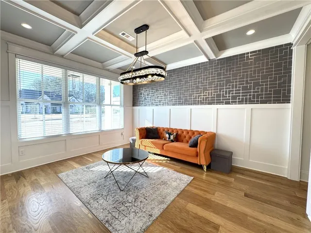 a living room with a couch and chandelier