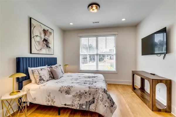a bedroom with a bed and a flat screen tv