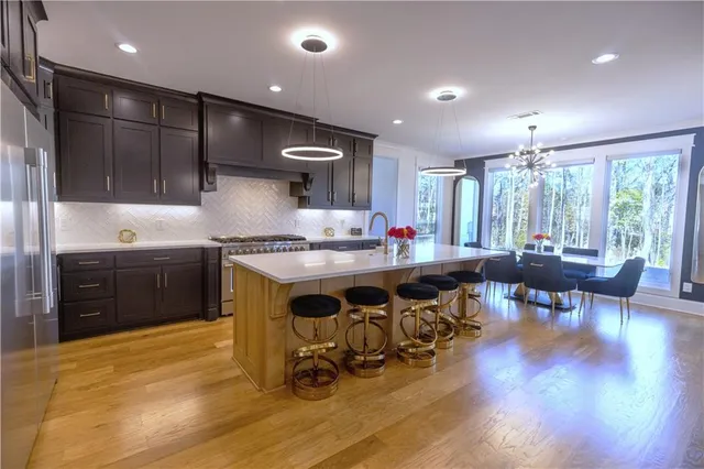 a kitchen with stainless steel appliances granite countertop a sink and a refrigerator