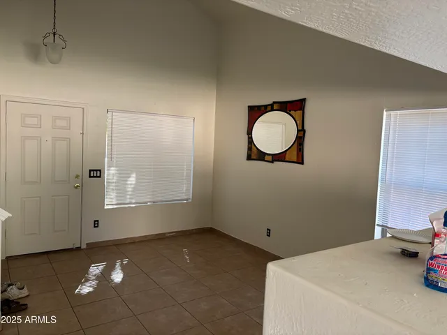 a view of a room with wooden floor and windows