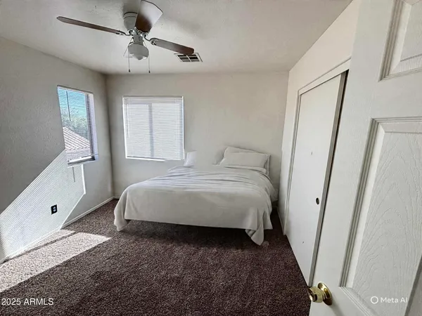 a bedroom with a large bed and a window