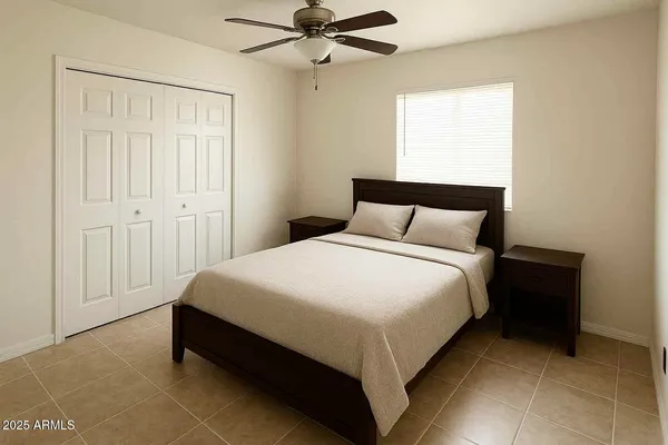 a bedroom with a bed and window