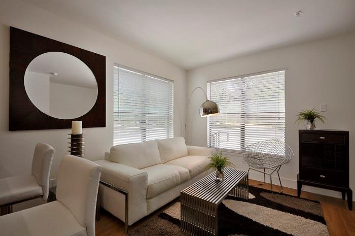 711 West 32nd Street, Unit 104 Austin, TX 78705 - Photo 3 of 11 a living room with furniture a window and a flat screen tv