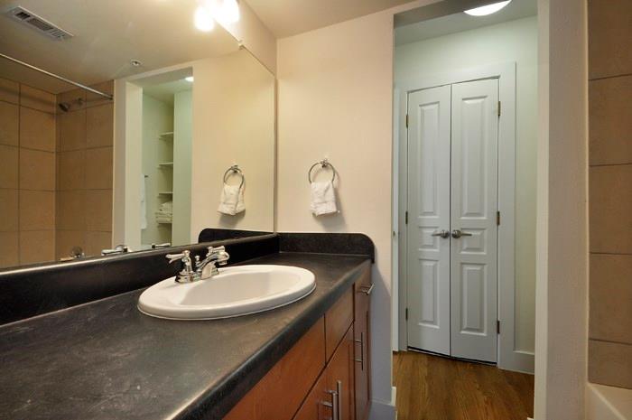 711 West 32nd Street, Unit 104 Austin, TX 78705 - Photo 6 of 11 a bathroom with a sink and a mirror