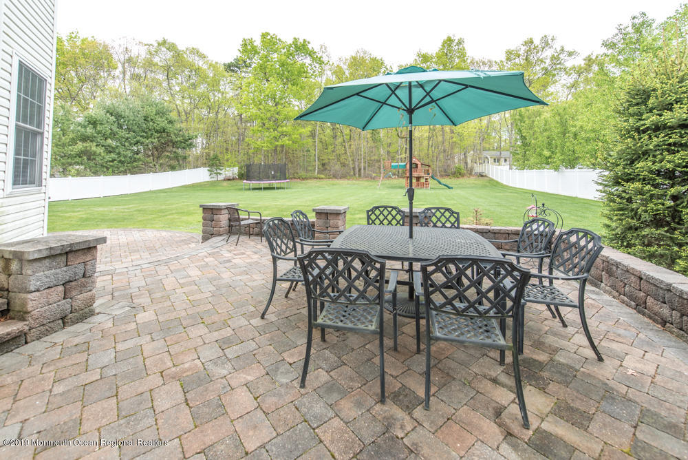 11 Round Hill Road Jackson, NJ 08527 - Photo 17 of 69 a view of patio with chairs and table under an umbrella
