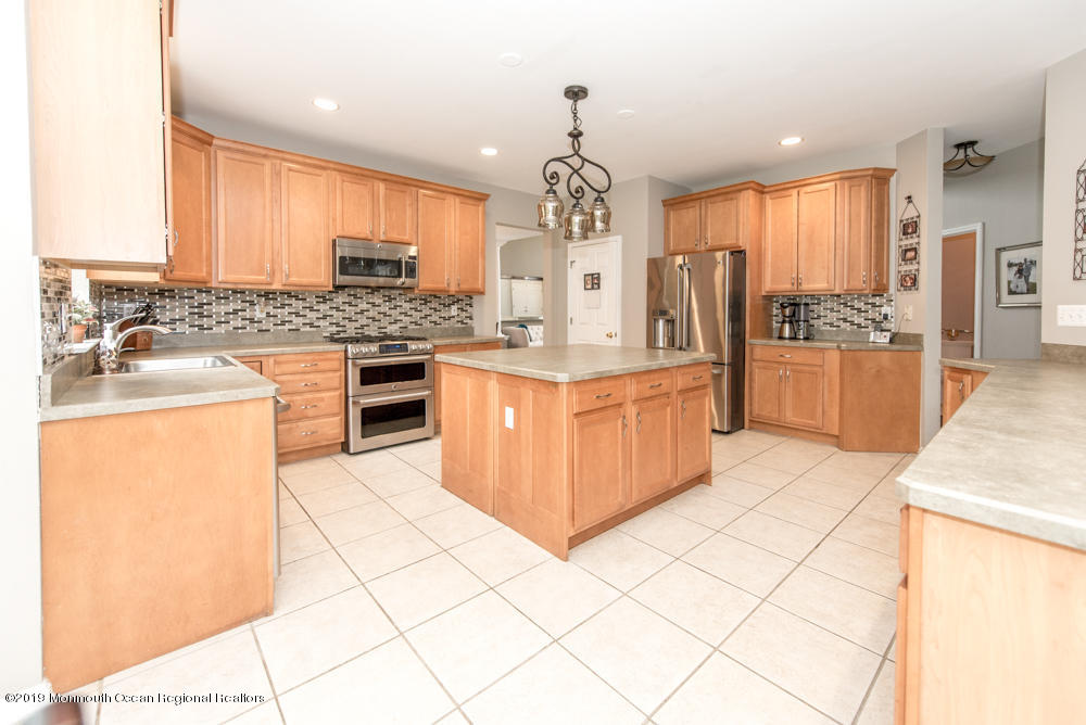 11 Round Hill Road Jackson, NJ 08527 - Photo 18 of 69 a kitchen with stainless steel appliances granite countertop a stove top oven a sink dishwasher and white cabinets