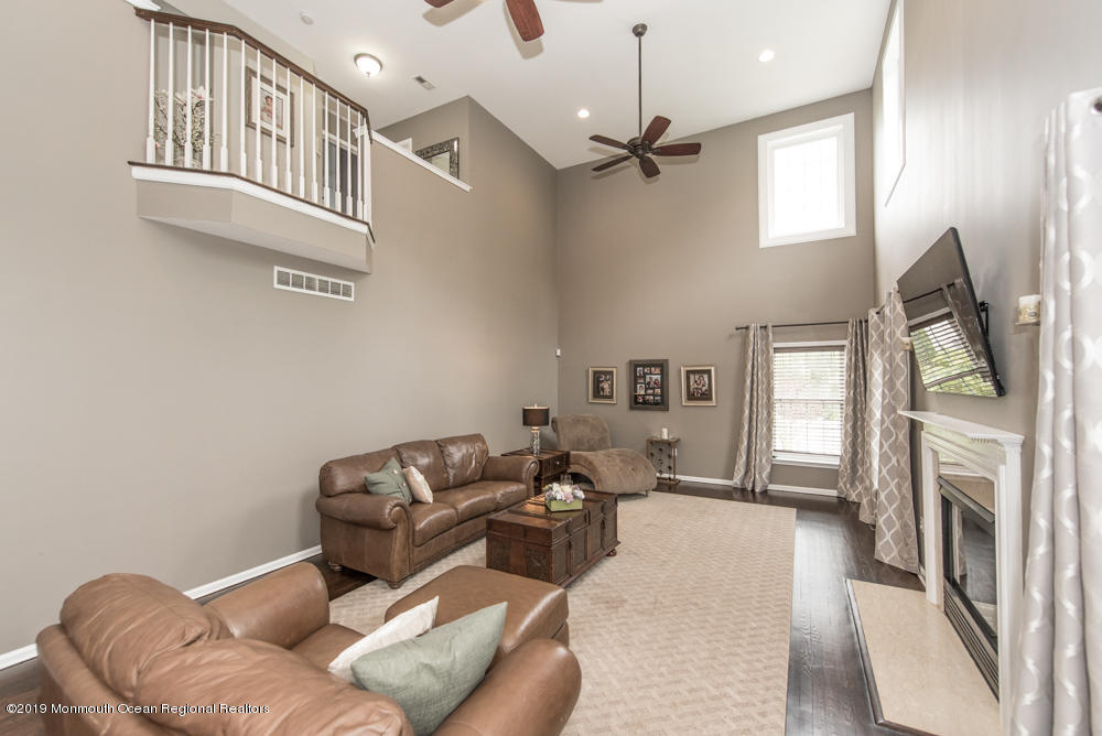 11 Round Hill Road Jackson, NJ 08527 - Photo 20 of 69 a living room with furniture and a fireplace