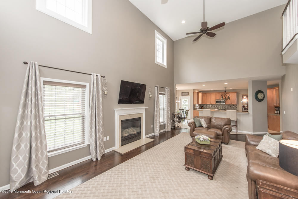 11 Round Hill Road Jackson, NJ 08527 - Photo 22 of 69 a living room with furniture a fireplace and a flat screen tv