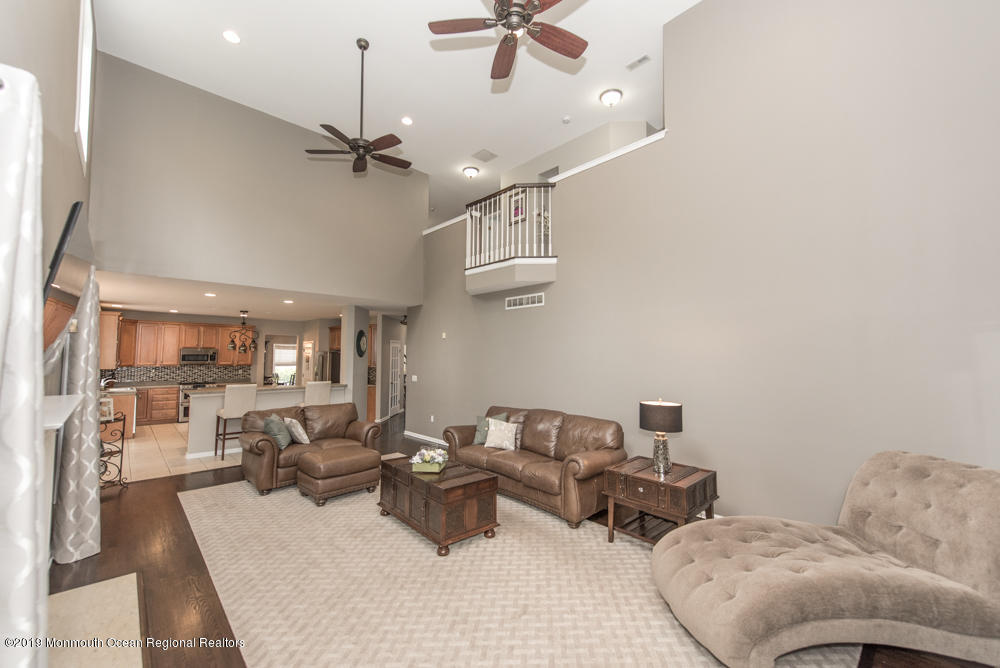 11 Round Hill Road Jackson, NJ 08527 - Photo 23 of 69 a living room with furniture and a chandelier