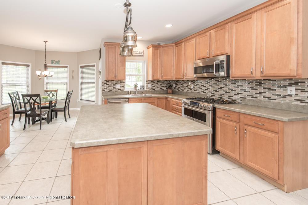 11 Round Hill Road Jackson, NJ 08527 - Photo 29 of 69 a kitchen with stainless steel appliances granite countertop a stove a sink a microwave and a refrigerator