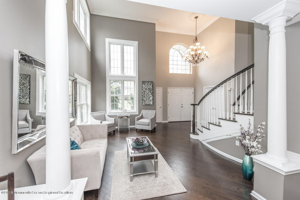 11 Round Hill Road Jackson, NJ 08527 - Photo 36 of 69 a living room with furniture and a chandelier