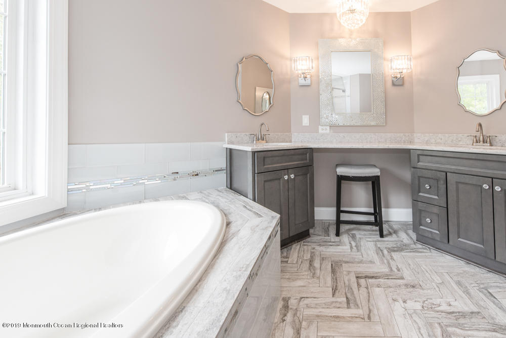 11 Round Hill Road Jackson, NJ 08527 - Photo 42 of 69 a spacious bathroom with a tub sink and a mirror