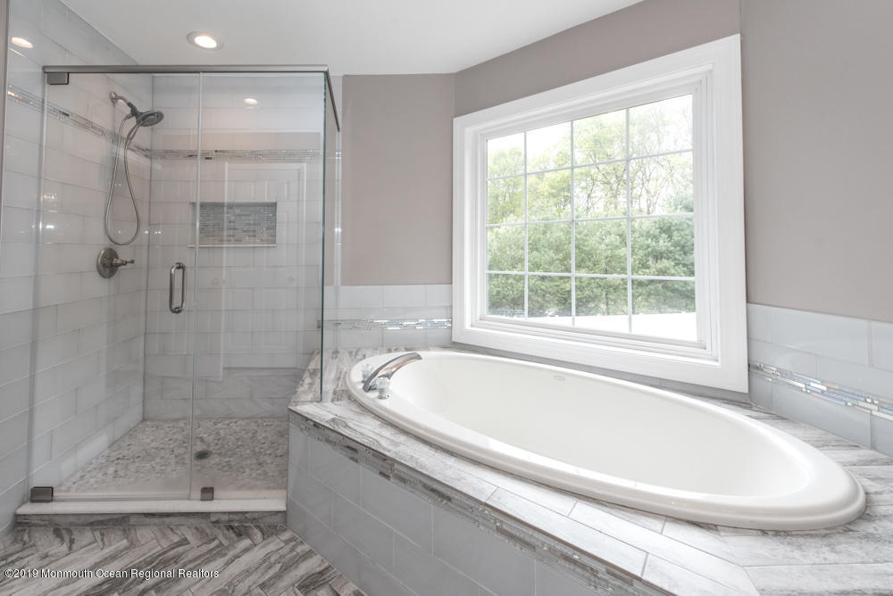 11 Round Hill Road Jackson, NJ 08527 - Photo 44 of 69 a white bath tub sitting next to a shower