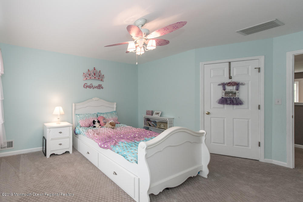 11 Round Hill Road Jackson, NJ 08527 - Photo 45 of 69 a bedroom with a bed and a chandelier