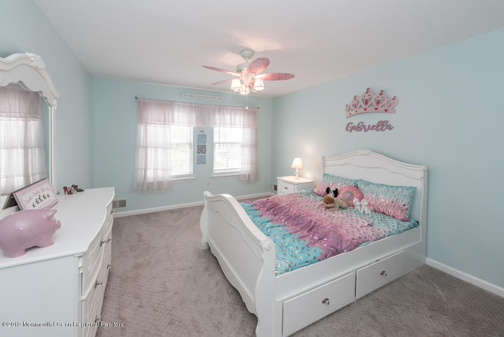 11 Round Hill Road Jackson, NJ 08527 - Photo 46 of 69 a spacious bedroom with a bed and a chandelier