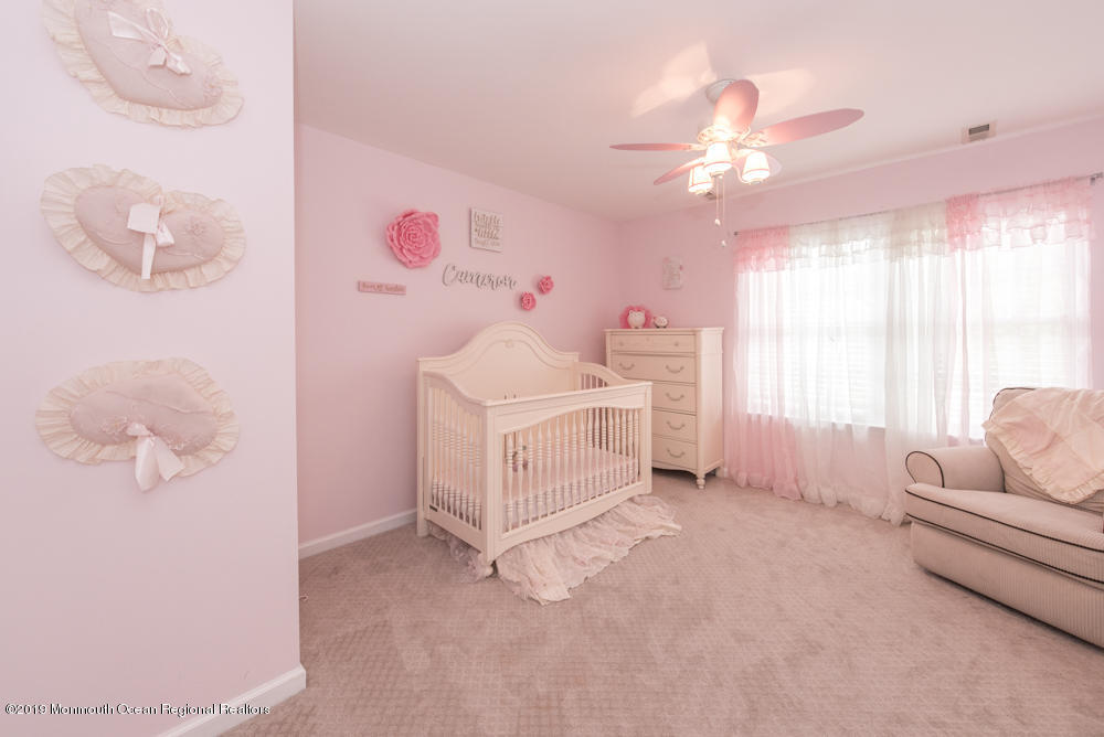 11 Round Hill Road Jackson, NJ 08527 - Photo 47 of 69 a bedroom with furniture and a chandelier