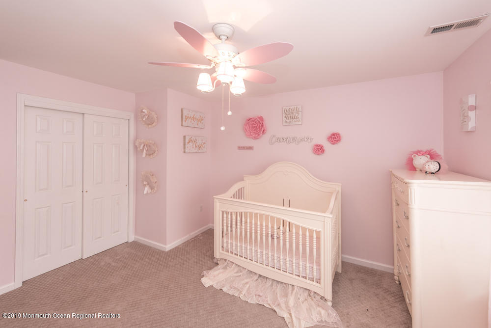 11 Round Hill Road Jackson, NJ 08527 - Photo 48 of 69 a bedroom with a bed and a chandelier